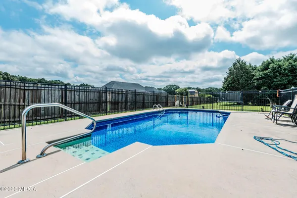 a view of a swimming pool with a lounge chair