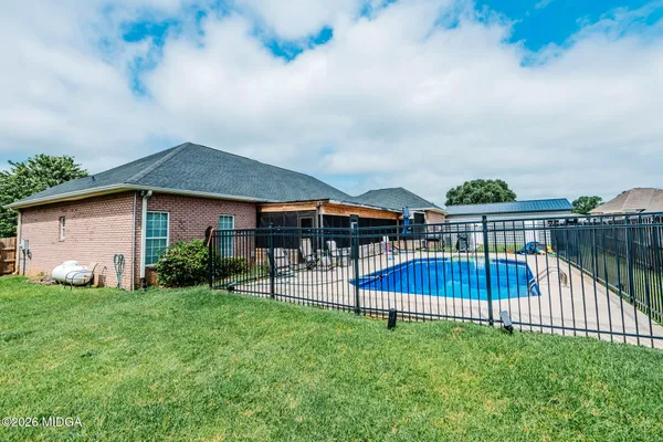 a view of house with backyard and patio