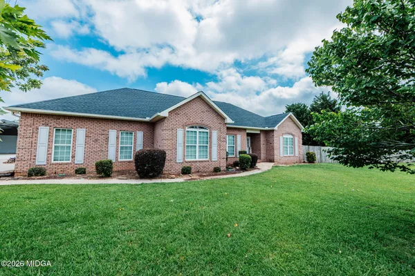 a front view of a house with a yard