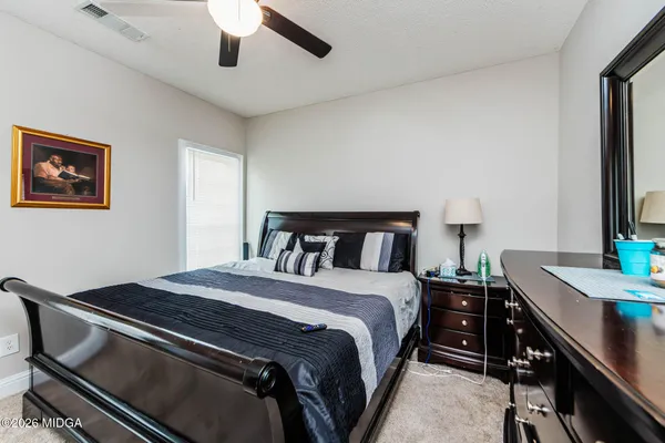 a bedroom with a bed and a desk