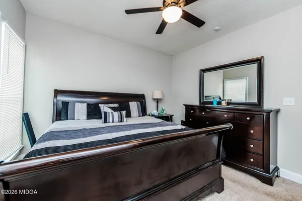 a bedroom with a bed and a dresser