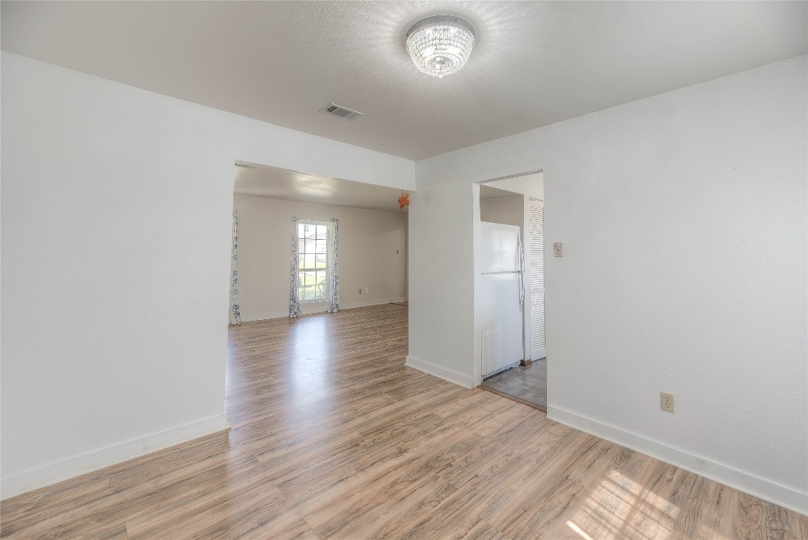 25634 Chestnut Lane Splendora, TX 77372 - Photo 12 of 45 an empty room with wooden floor and mirror