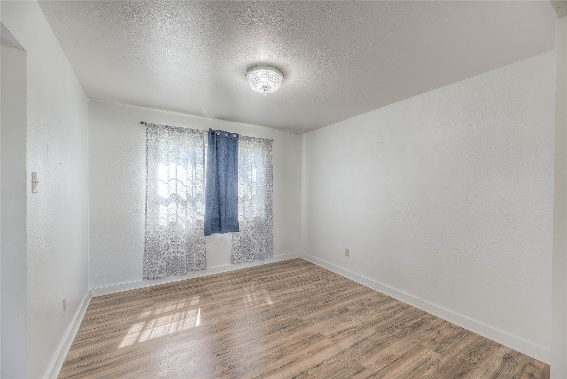 25634 Chestnut Lane Splendora, TX 77372 - Photo 13 of 45 an empty room with wooden floor and windows