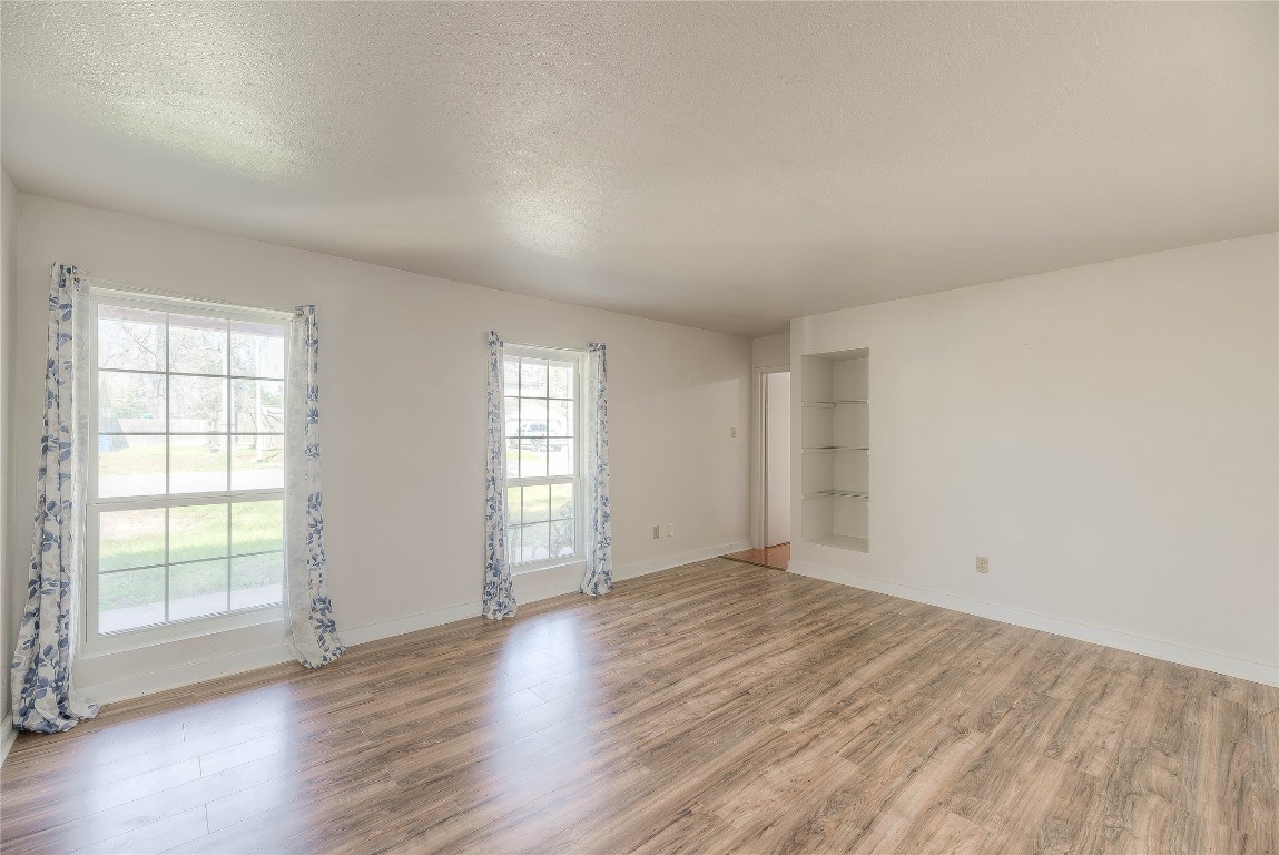 25634 Chestnut Lane Splendora, TX 77372 - Photo 14 of 45 an empty room with wooden floor and windows