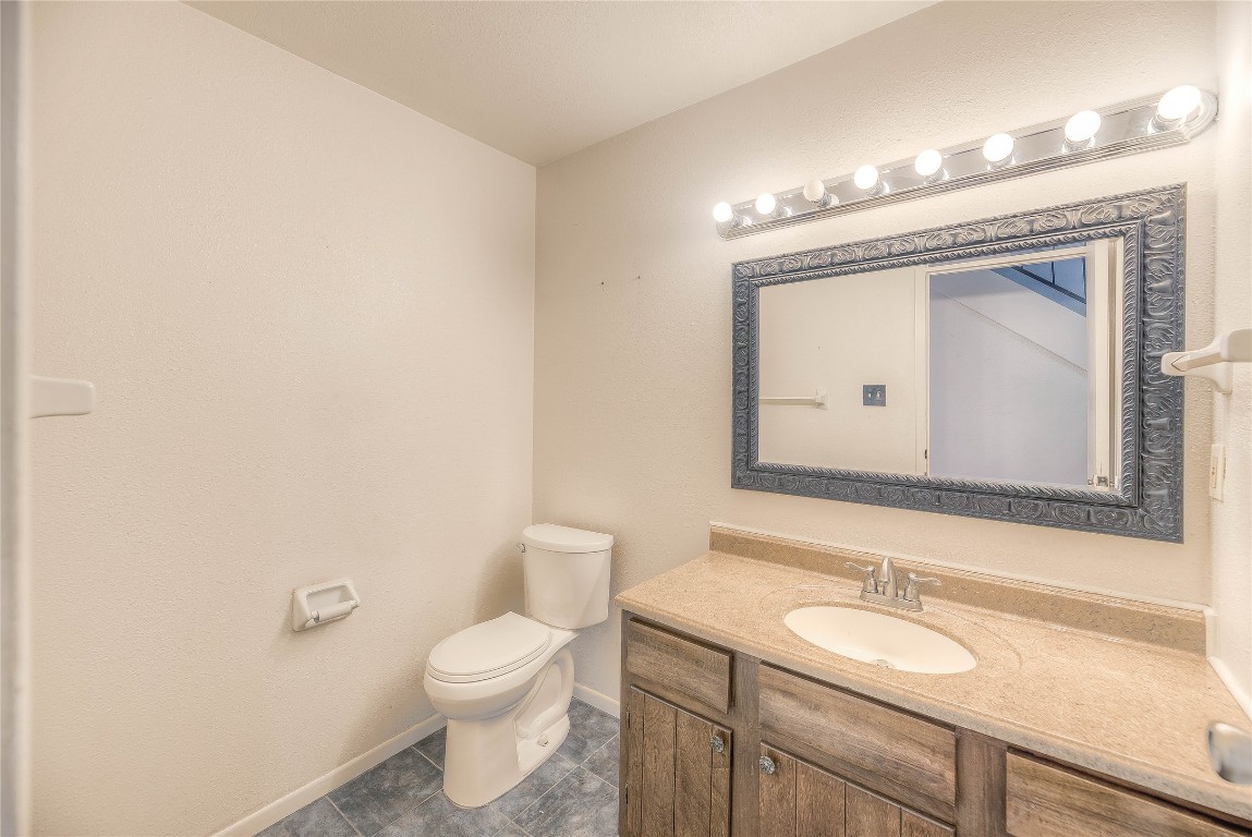 25634 Chestnut Lane Splendora, TX 77372 - Photo 16 of 45 a bathroom with a toilet a sink and mirror