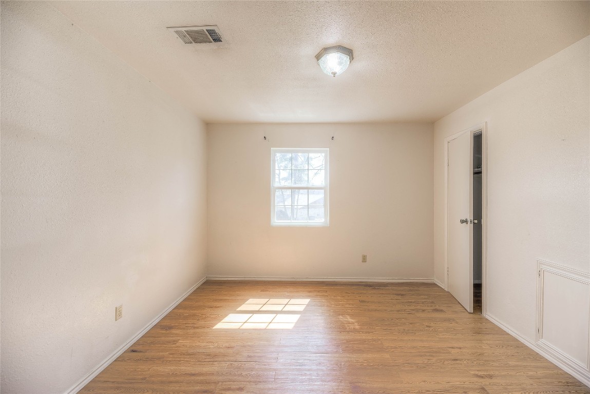 25634 Chestnut Lane Splendora, TX 77372 - Photo 18 of 45 an empty room with wooden floor and windows