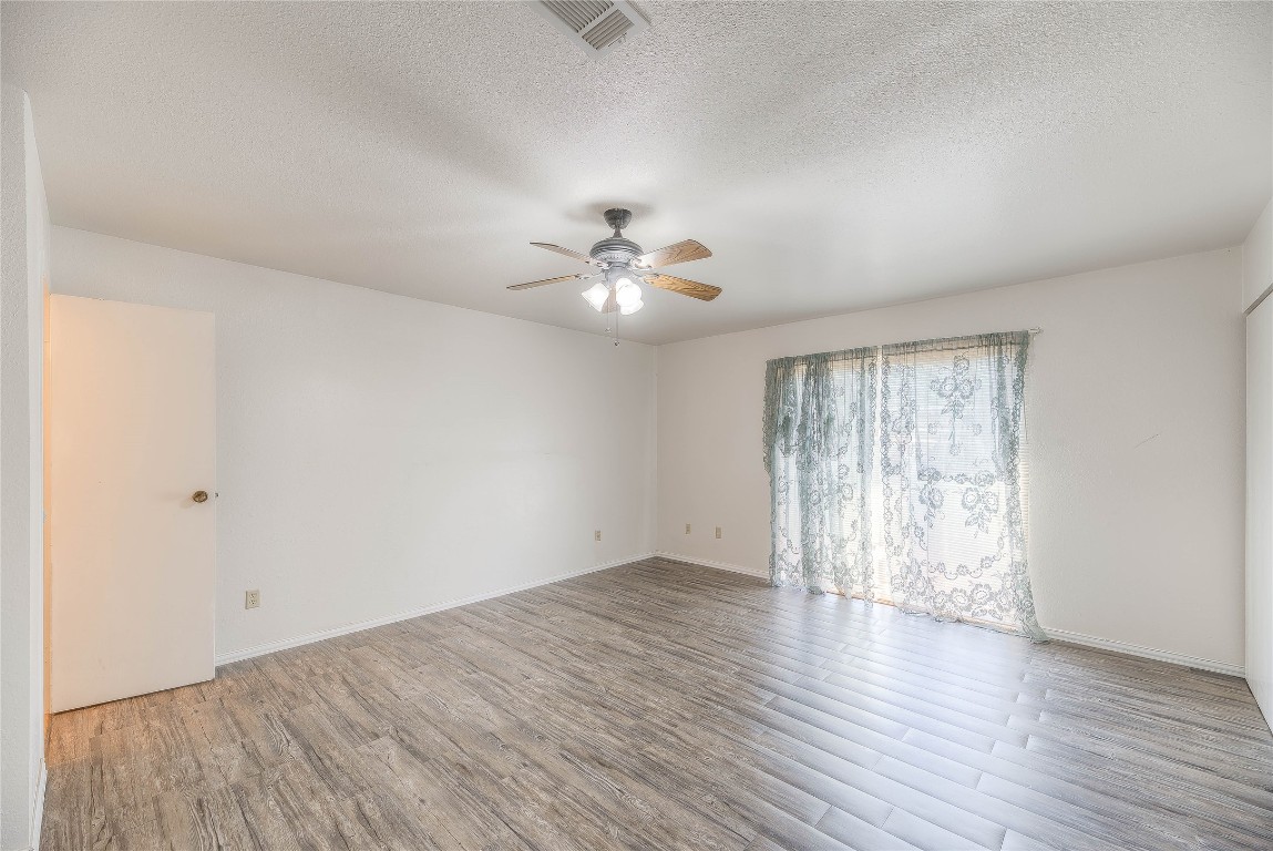 25634 Chestnut Lane Splendora, TX 77372 - Photo 22 of 45 an empty room with wooden floor and windows