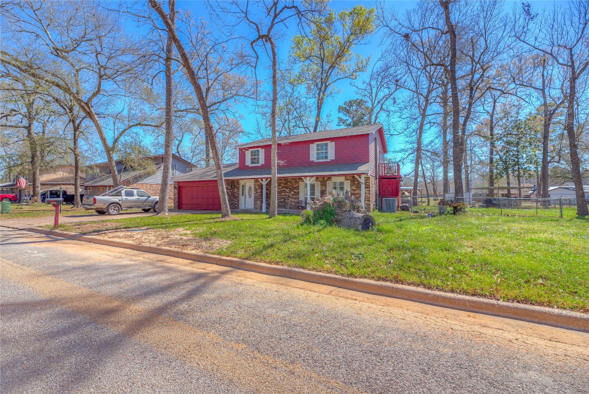 25634 Chestnut Lane Splendora, TX 77372 - Photo 26 of 45 a view of a brick building with a yard