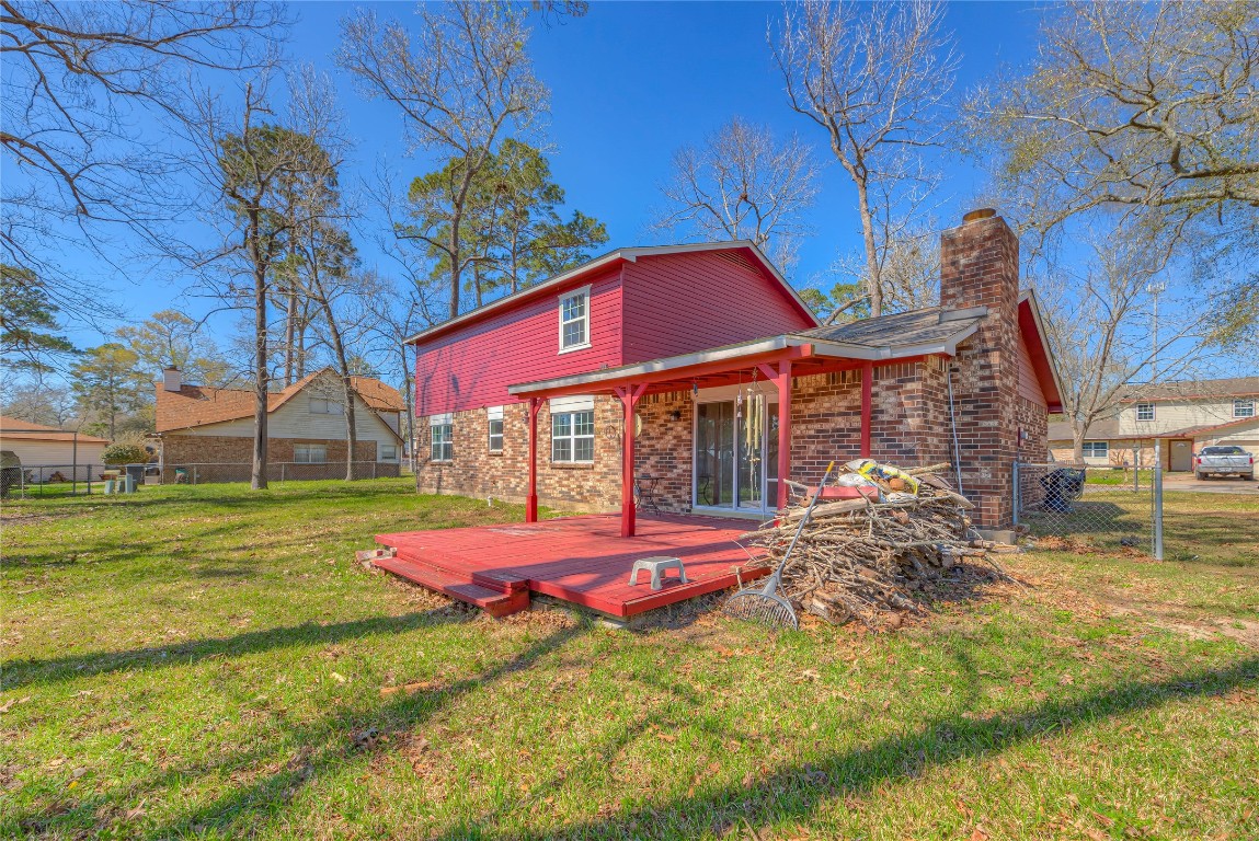 25634 Chestnut Lane Splendora, TX 77372 - Photo 29 of 45 a backyard of a house with table and chairs