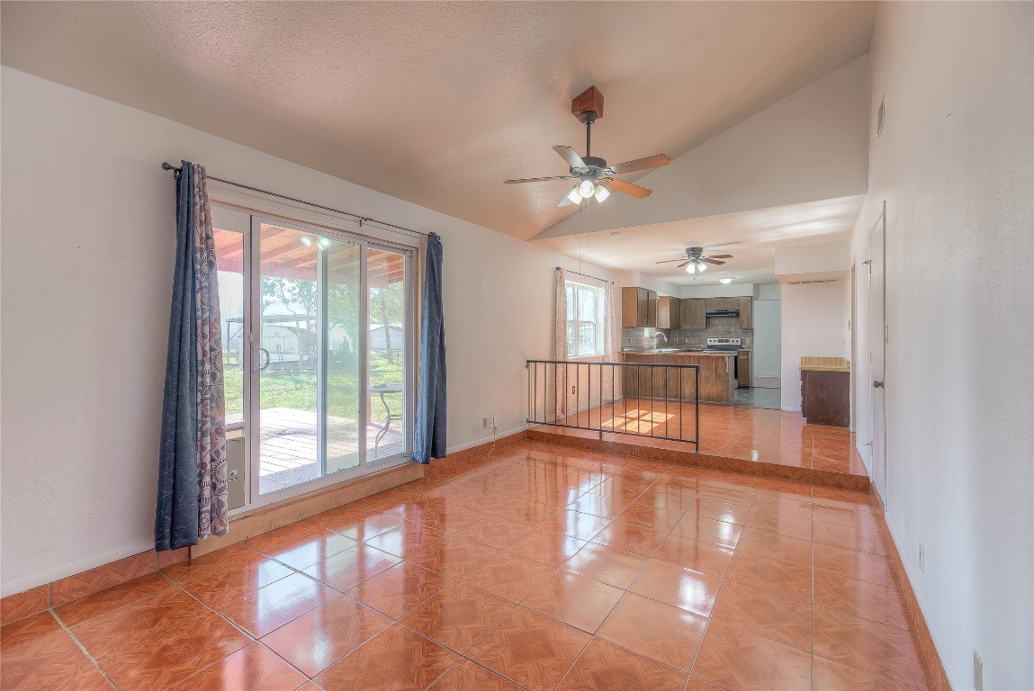 25634 Chestnut Lane Splendora, TX 77372 - Photo 6 of 45 a view of an empty room with a window and a kitchen