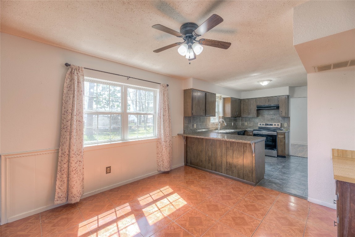 25634 Chestnut Lane Splendora, TX 77372 - Photo 7 of 45 a kitchen with stainless steel appliances granite countertop a sink cabinets and window