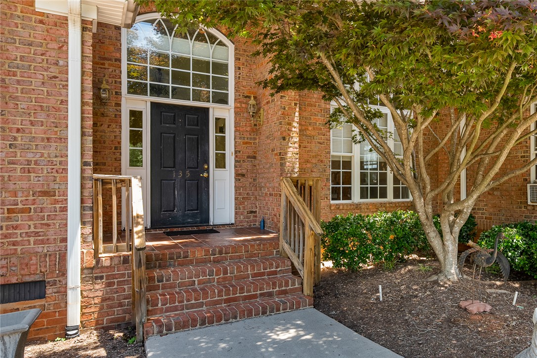 135 Sunset Bay Boulevard Seneca, SC 29672 - Photo 5 of 50 A classic brick facade welcomes with an arched transom window above the entry.