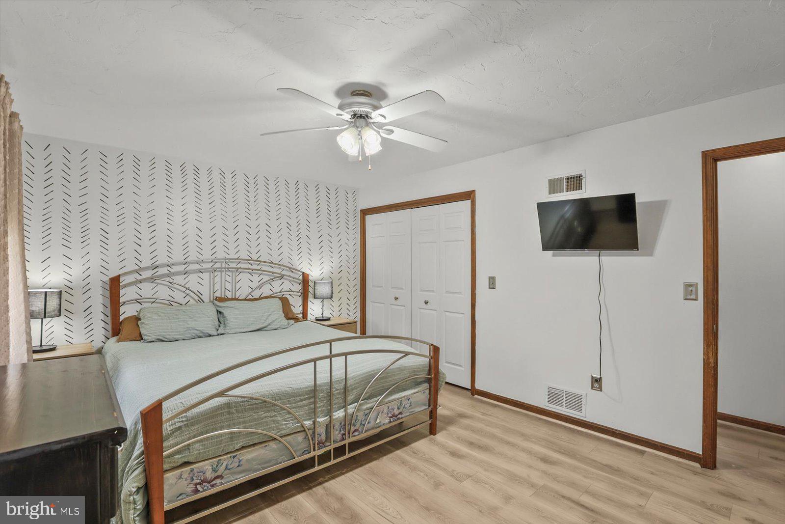 113 Timber Lane Hanover, PA 17331 - Photo 24 of 43 a bedroom with a bed and a flat tv screen on dresser