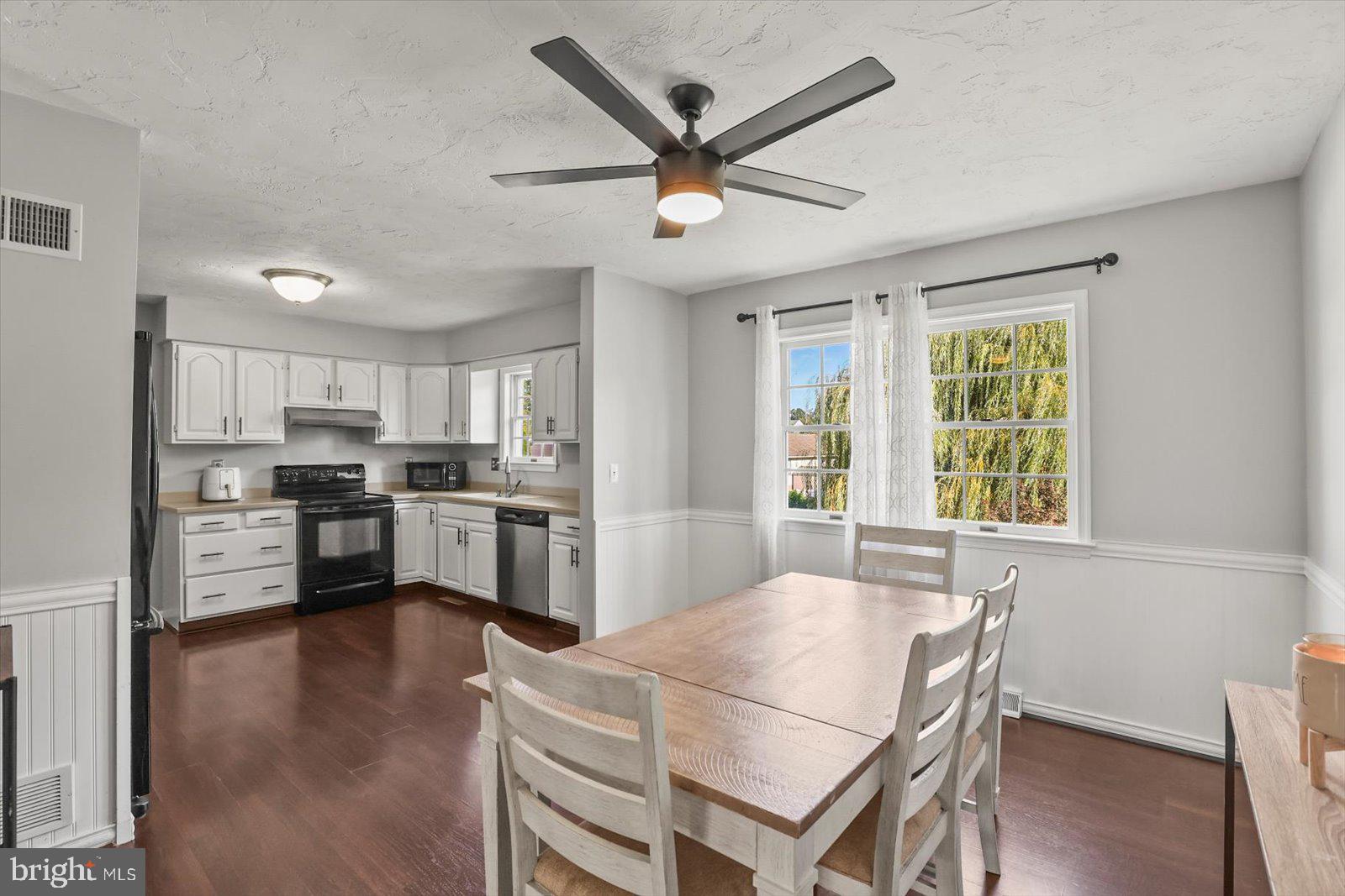 113 Timber Lane Hanover, PA 17331 - Photo 5 of 43 a kitchen with stainless steel appliances kitchen island granite countertop a refrigerator a stove a sink a dining table and chairs with wooden floor