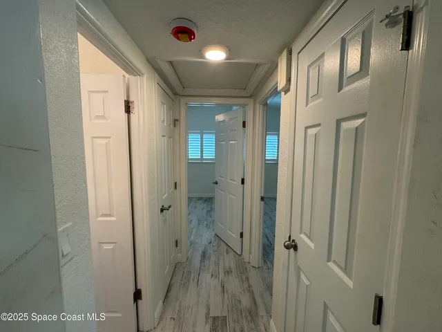 a bathroom with a glass shower door and a sink