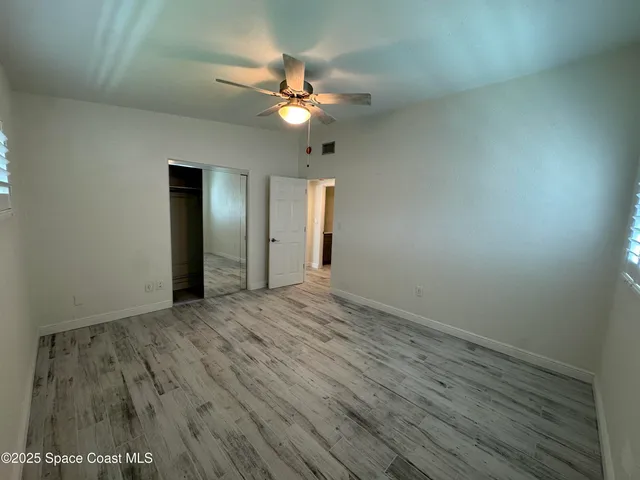 wooden floor in an empty room with a mirror