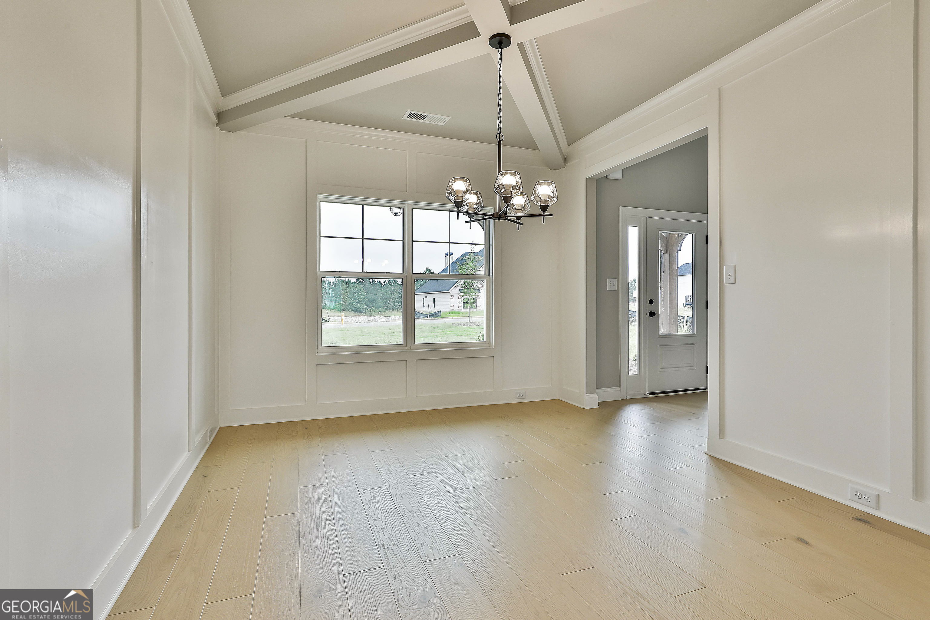 291 Grove Park, Unit 90 Senoia, GA 30276 - Photo 13 of 53 an empty room with chandelier fan and windows