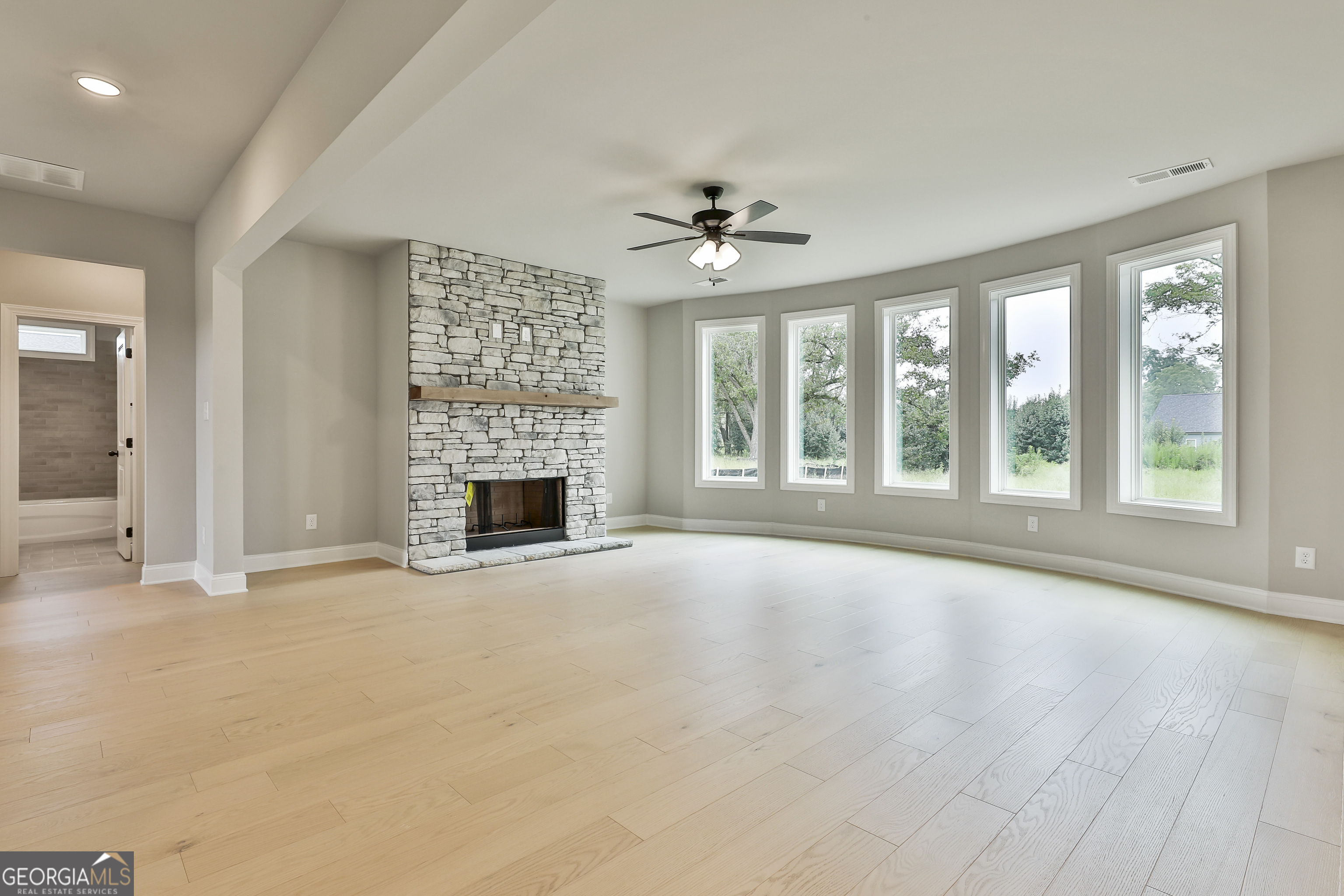 291 Grove Park, Unit 90 Senoia, GA 30276 - Photo 15 of 53 a view of an empty room with a fireplace and a window