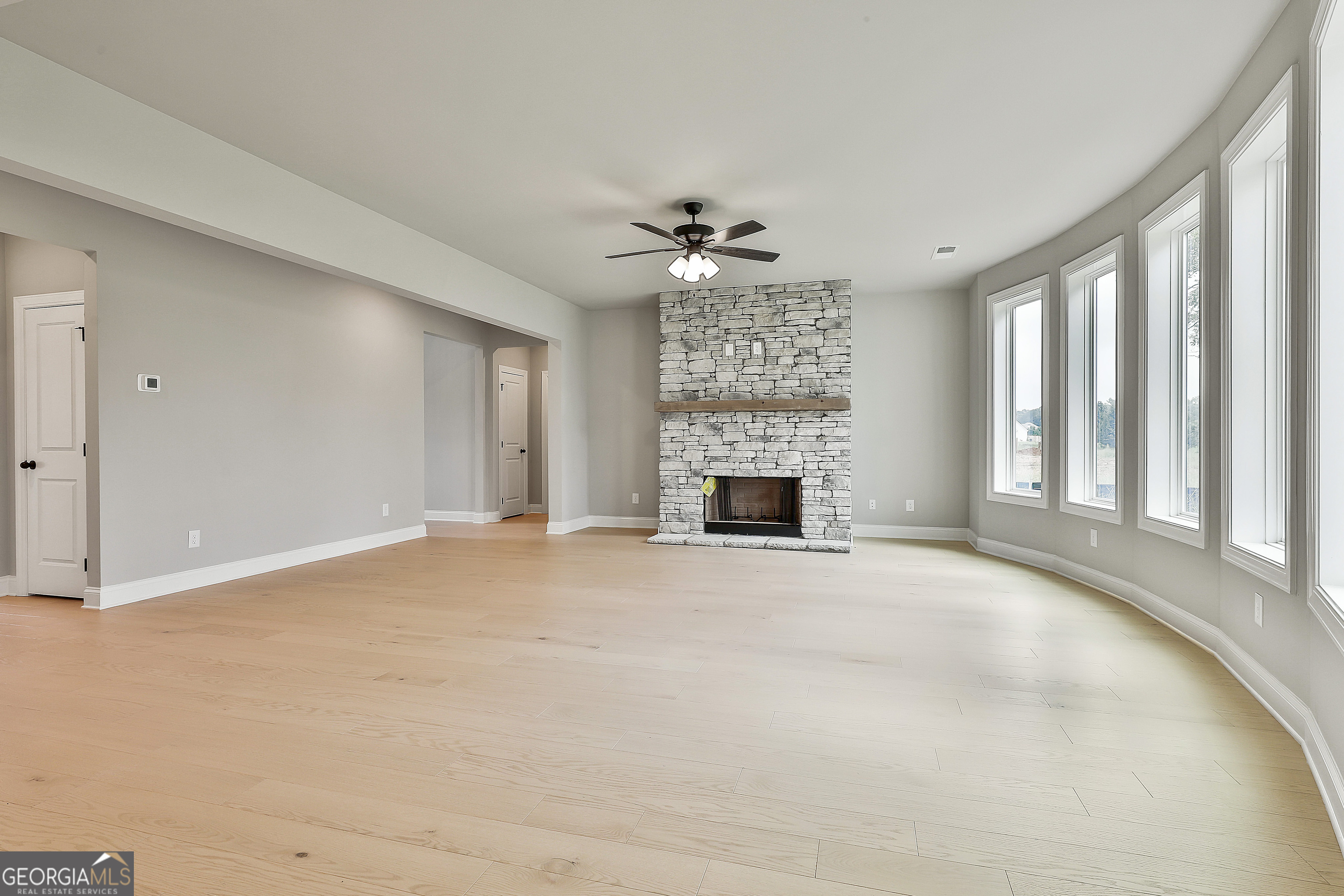 291 Grove Park, Unit 90 Senoia, GA 30276 - Photo 16 of 53 a view of an empty room with a fireplace and a window