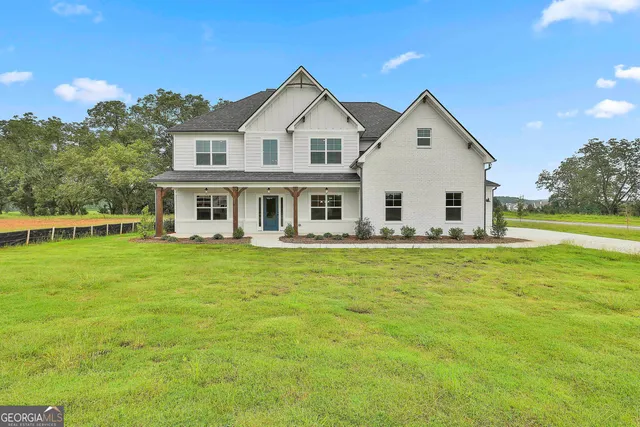 a front view of a house with a garden