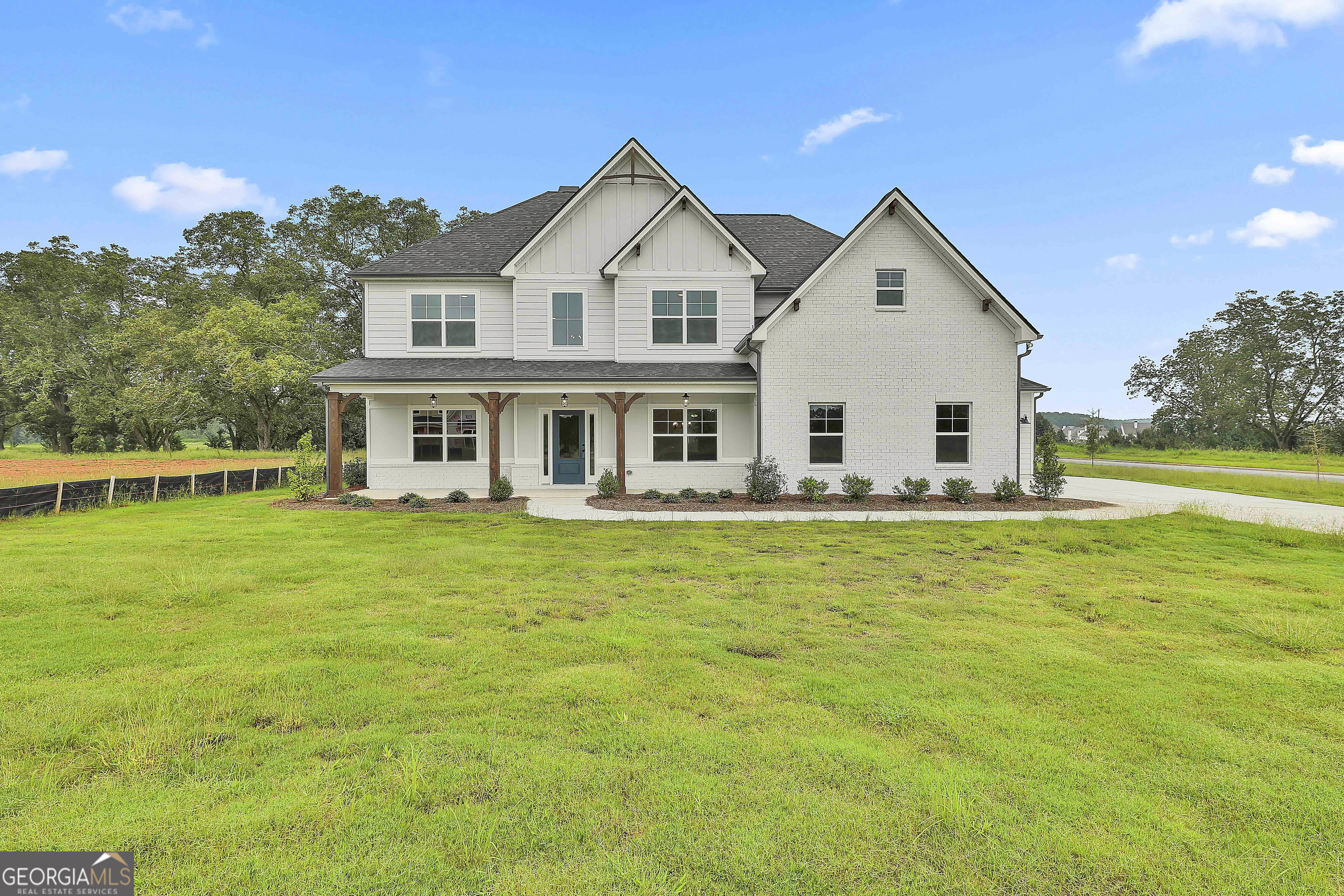 291 Grove Park, Unit 90 Senoia, GA 30276 - Photo 2 of 53 a front view of a house with a garden