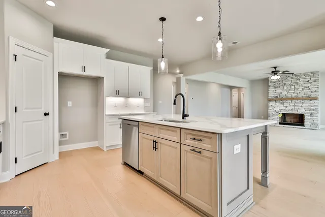 a kitchen with kitchen island a sink stainless steel appliances and cabinets