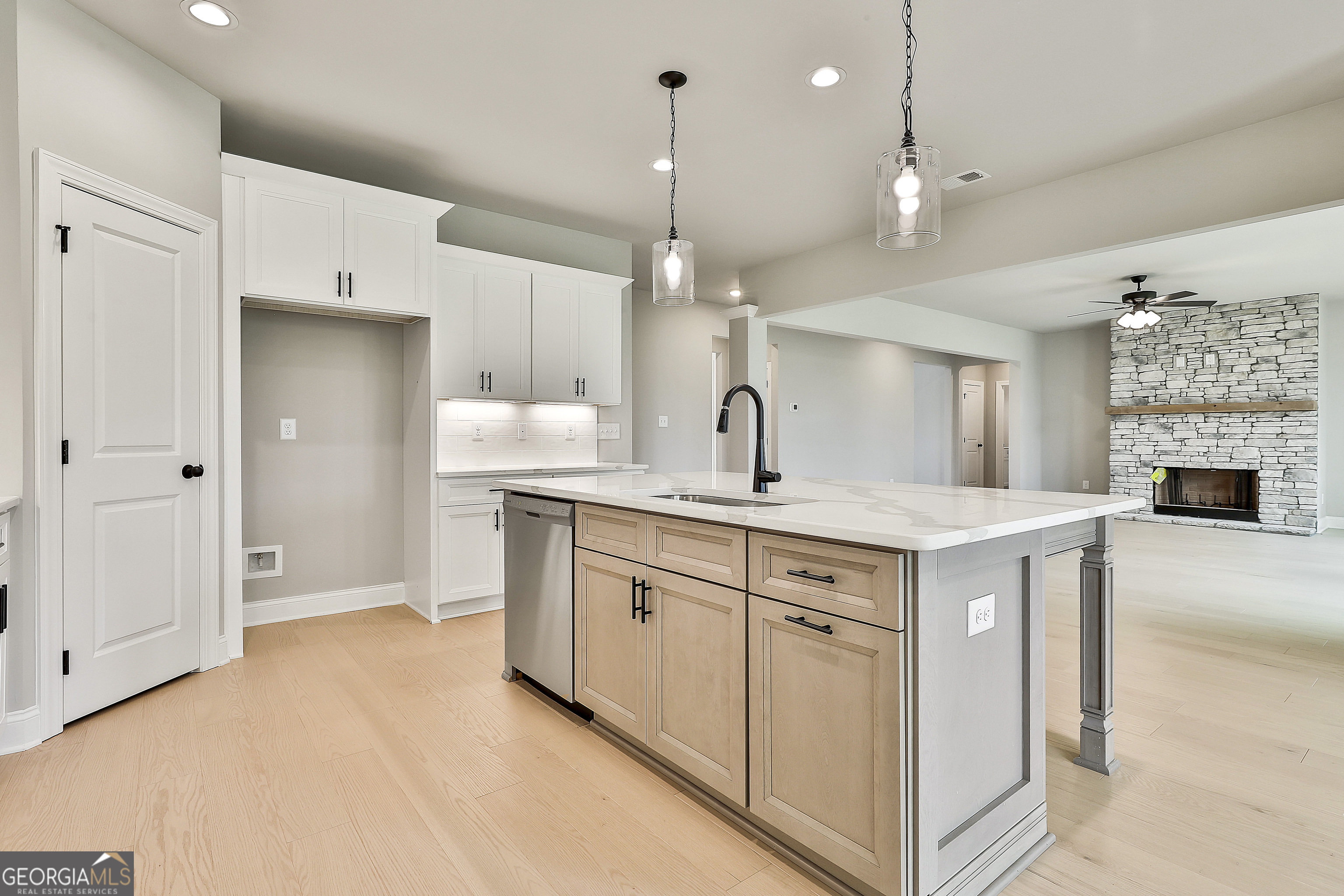291 Grove Park, Unit 90 Senoia, GA 30276 - Photo 25 of 53 a kitchen with kitchen island a sink stainless steel appliances and cabinets