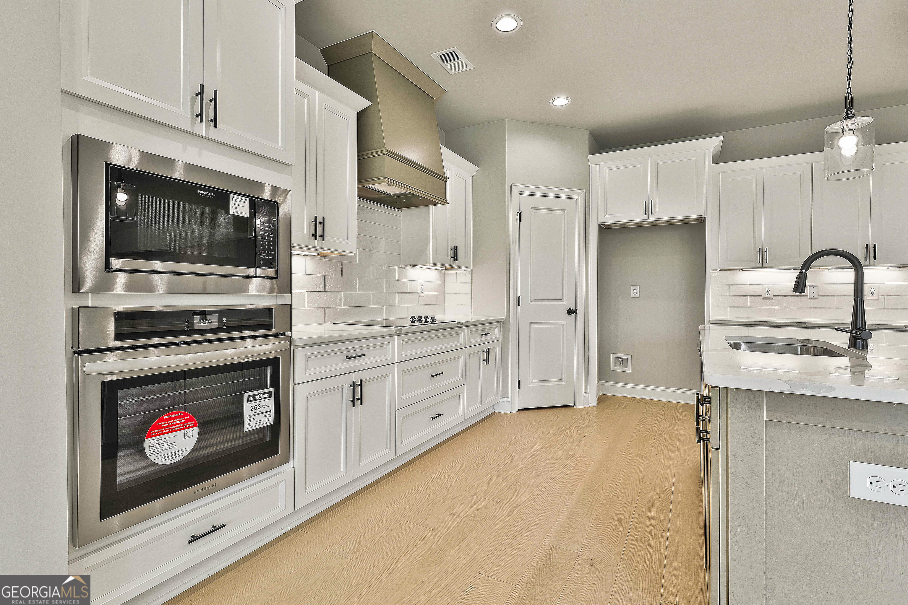 291 Grove Park, Unit 90 Senoia, GA 30276 - Photo 27 of 53 a kitchen with stainless steel appliances a stove microwave and a sink