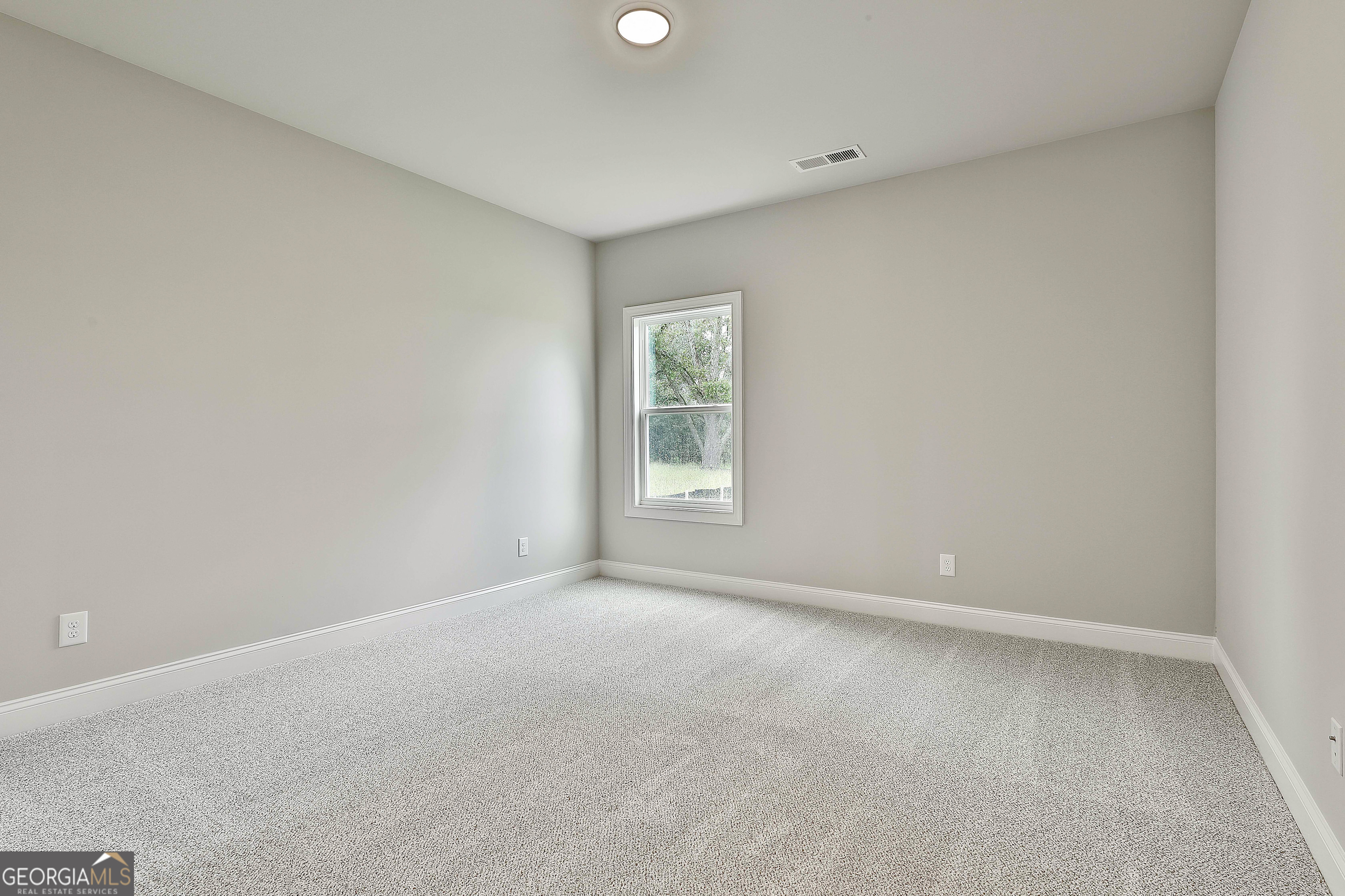 291 Grove Park, Unit 90 Senoia, GA 30276 - Photo 29 of 53 a view of an empty room with a window