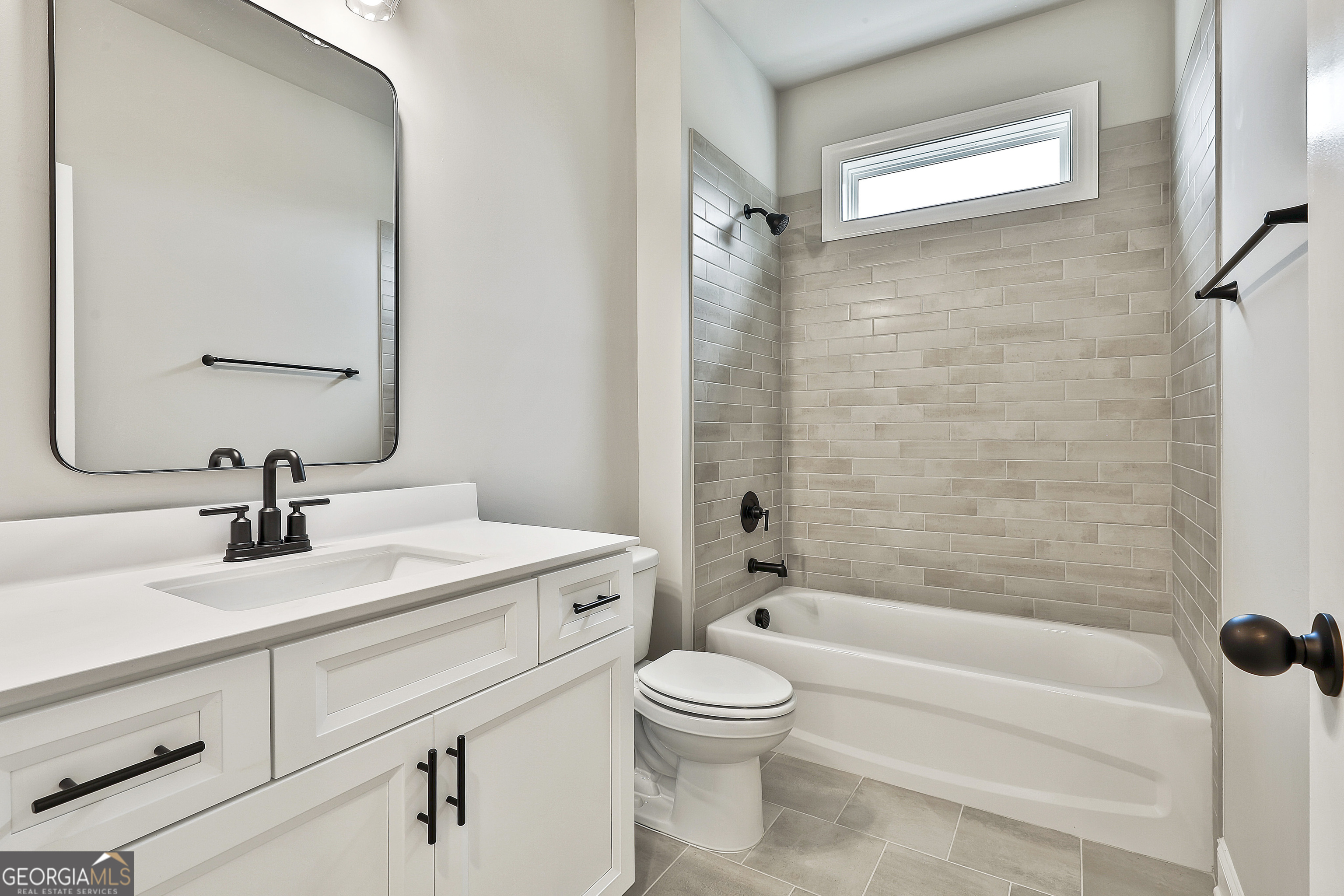 291 Grove Park, Unit 90 Senoia, GA 30276 - Photo 30 of 53 a bathroom with a sink a toilet and a mirror