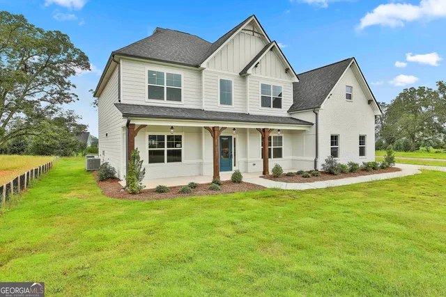 a front view of a house with a yard and porch