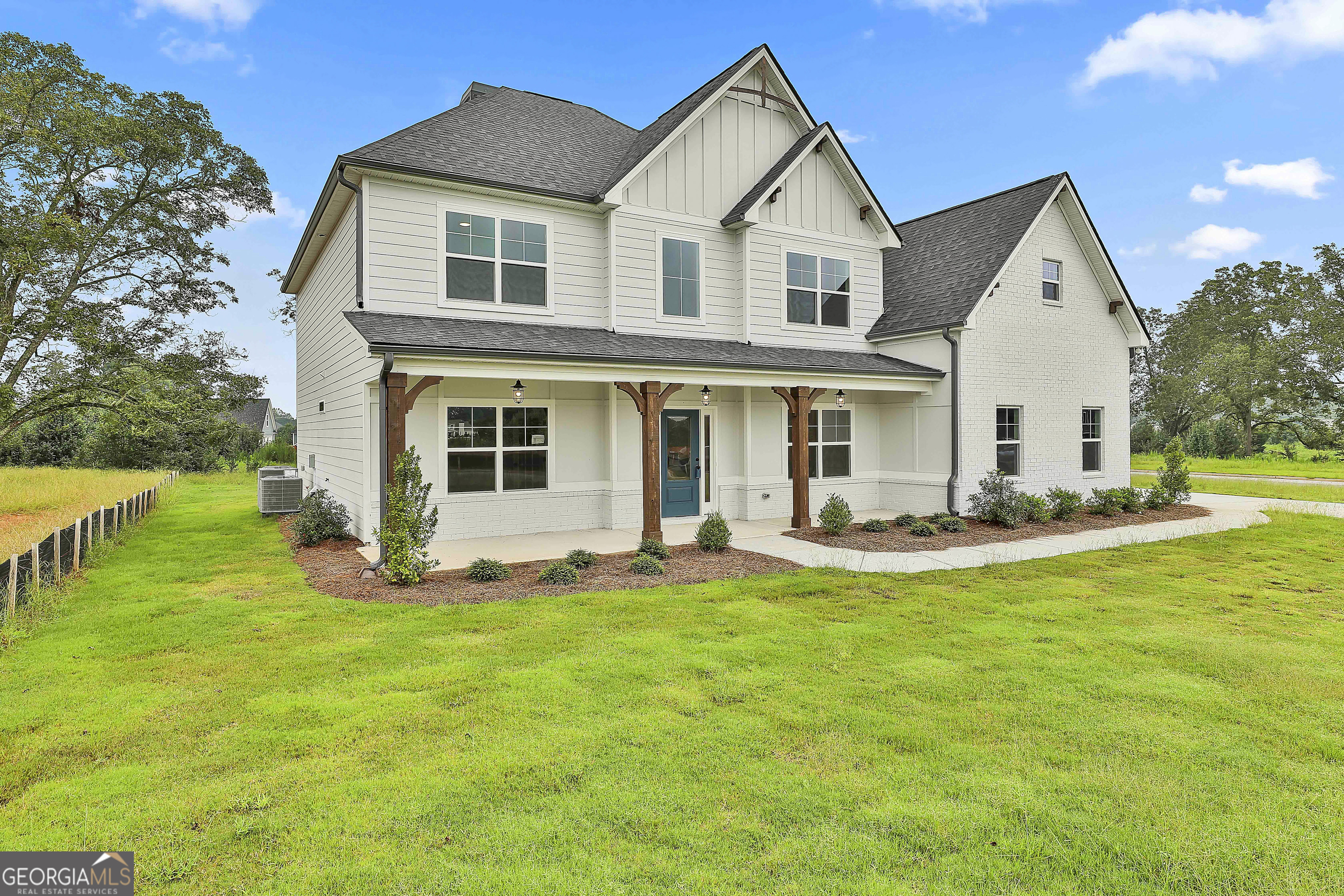 291 Grove Park, Unit 90 Senoia, GA 30276 - Photo 3 of 53 a front view of a house with a yard and porch
