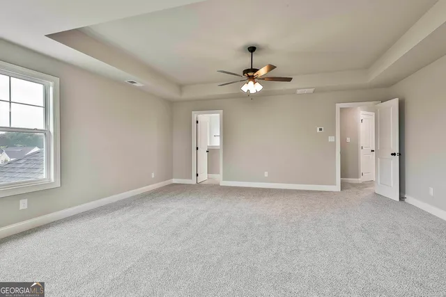 a spacious bathroom with double sink and a mirror