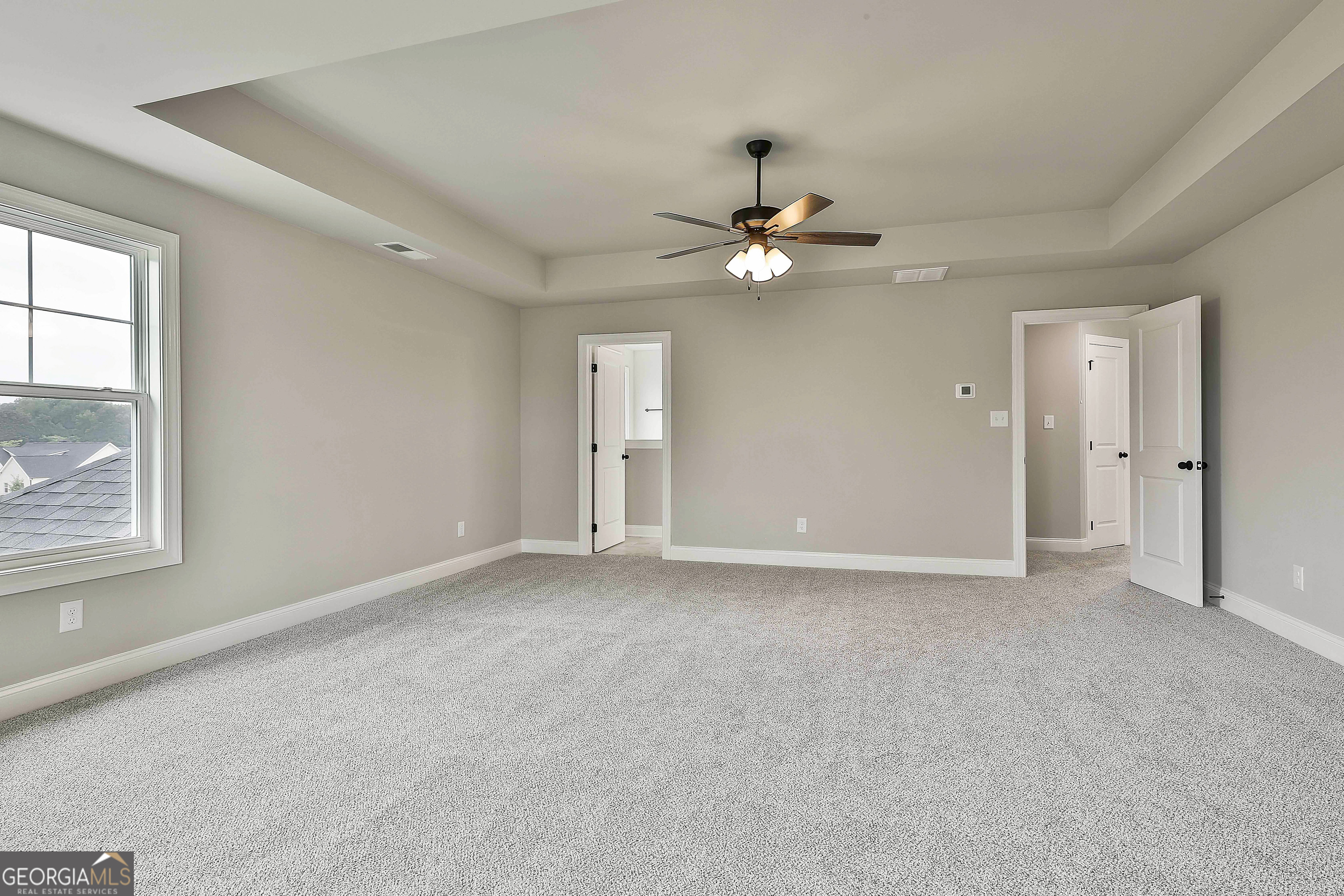 291 Grove Park, Unit 90 Senoia, GA 30276 - Photo 37 of 53 an empty room with windows and fan