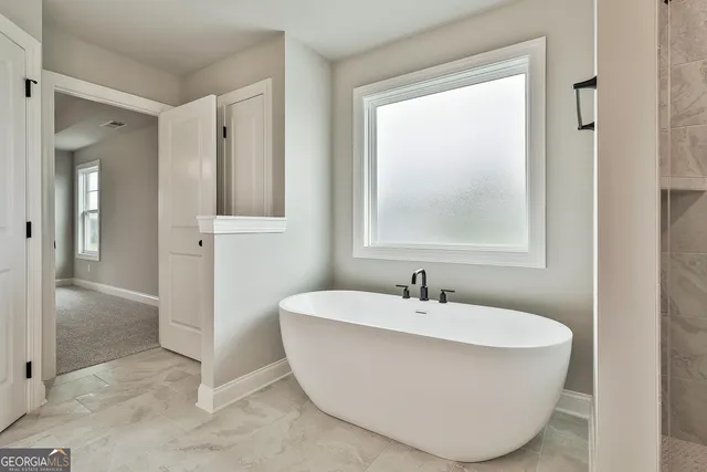 a bathroom with double vanity sinks and a mirror