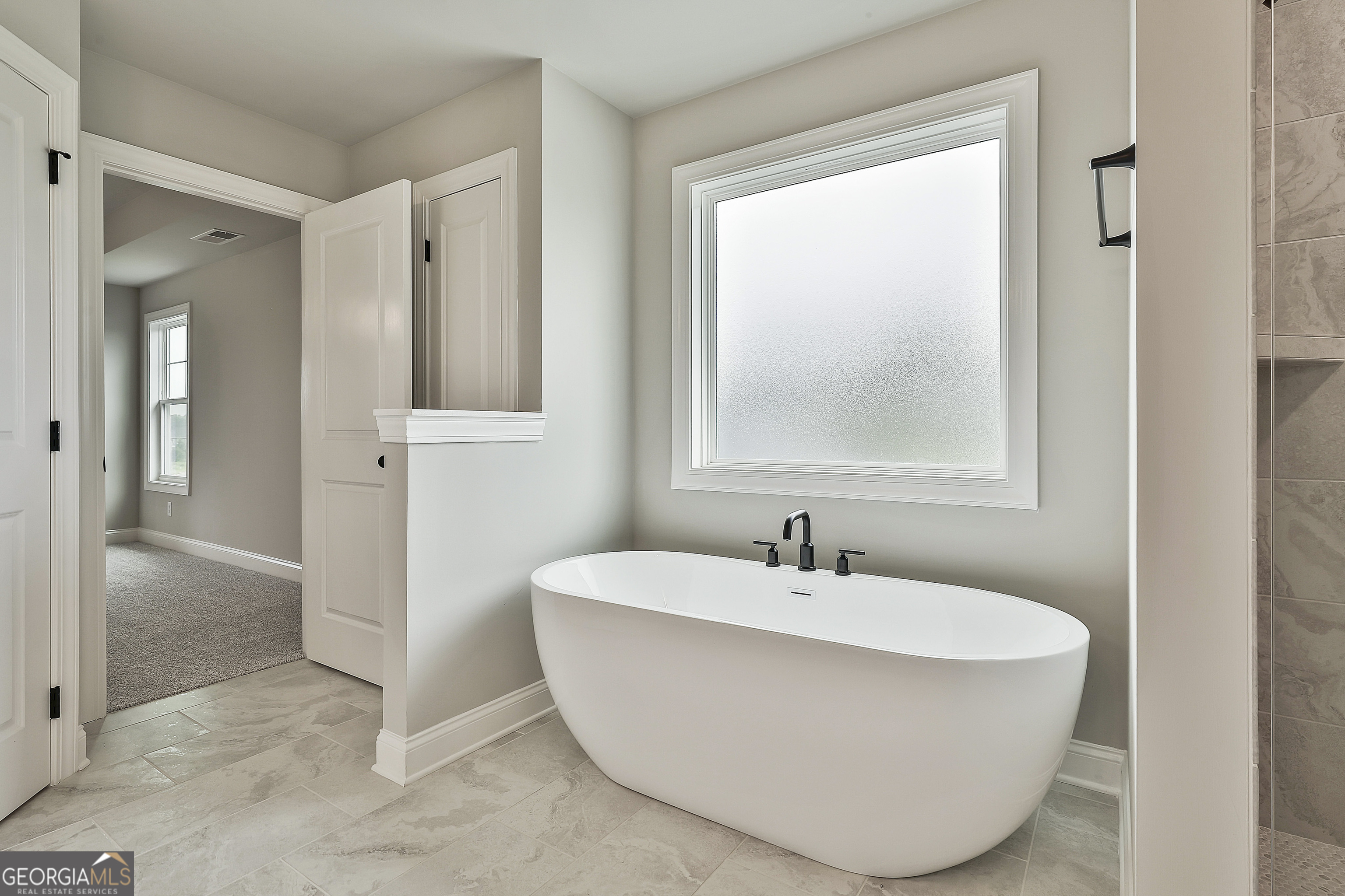 291 Grove Park, Unit 90 Senoia, GA 30276 - Photo 40 of 53 a white tub sitting next to a bathroom sink