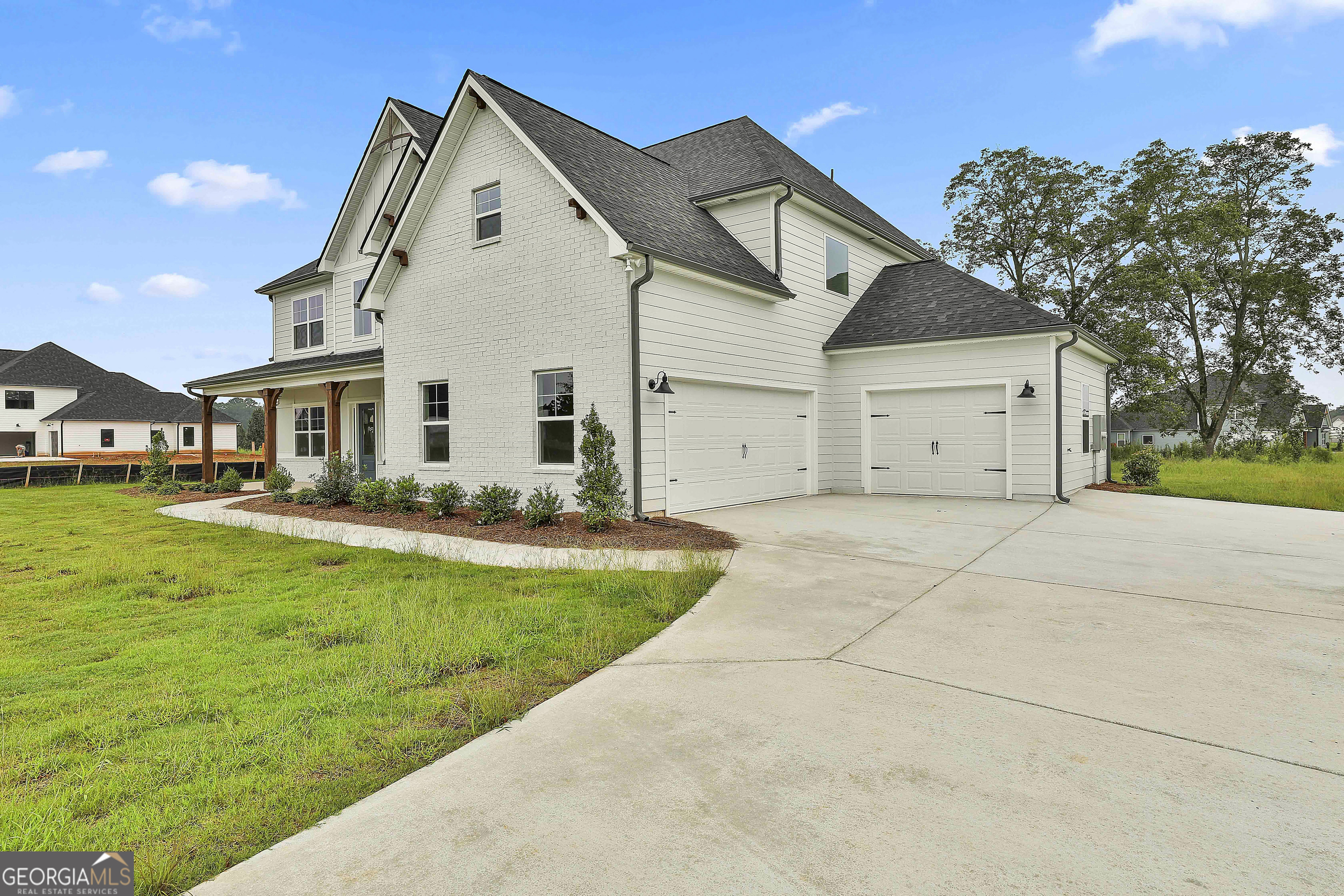 291 Grove Park, Unit 90 Senoia, GA 30276 - Photo 4 of 53 a view of a white house with a big yard and large trees