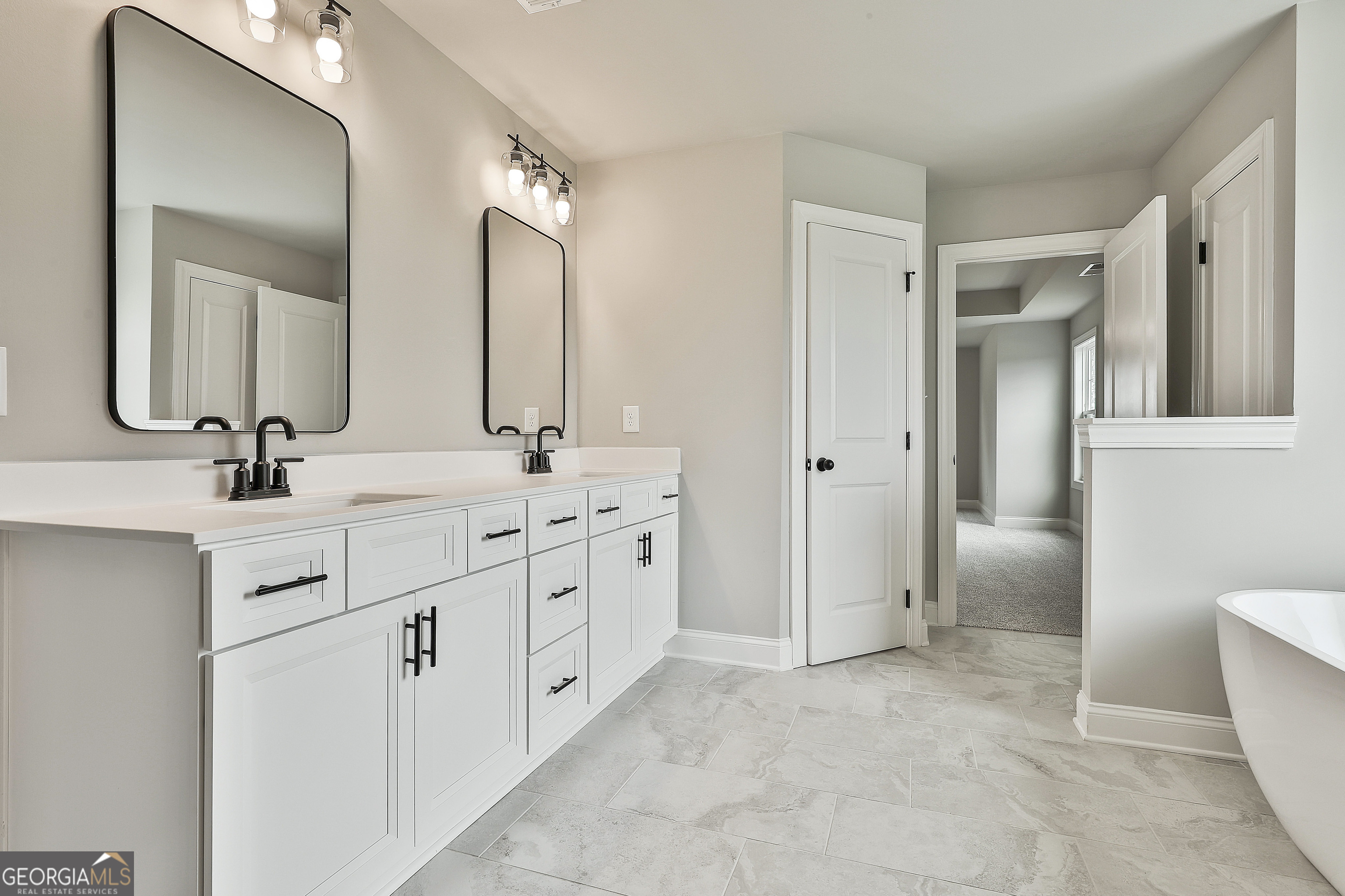 291 Grove Park, Unit 90 Senoia, GA 30276 - Photo 41 of 53 a bathroom with double vanity sinks and a mirror
