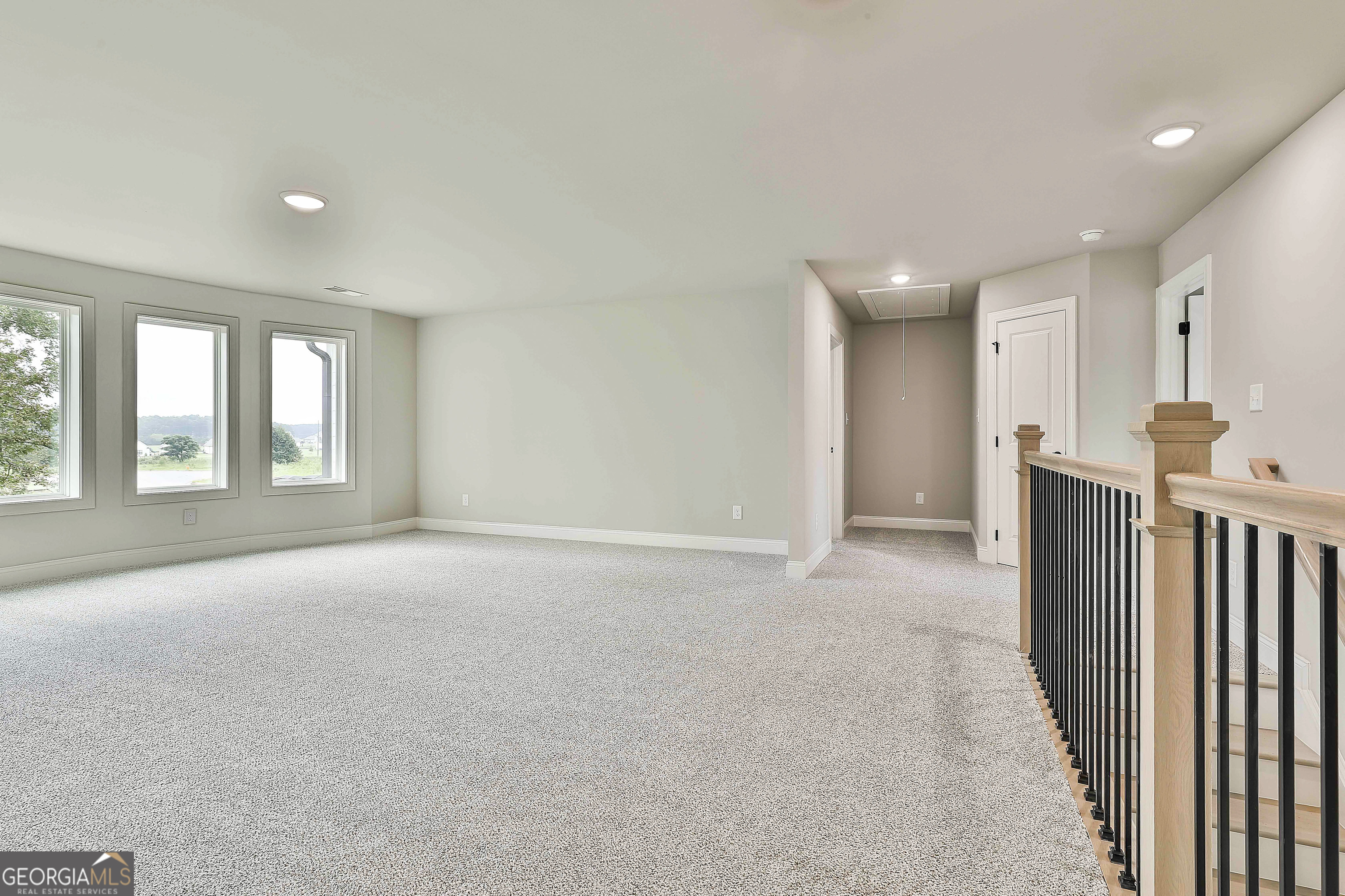 291 Grove Park, Unit 90 Senoia, GA 30276 - Photo 48 of 53 a view of an empty room with a fireplace and a window