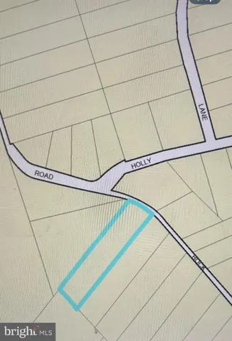 a sign that is sitting in front of a tree