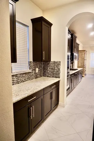 a kitchen with a kitchen island wooden cabinets and stainless steel appliances