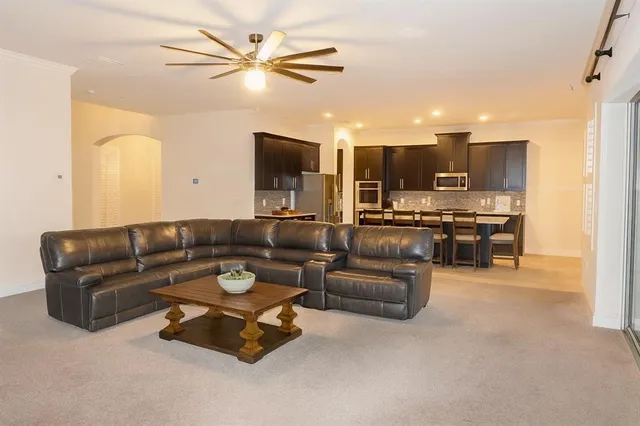 a bedroom with a bed chair and a large window