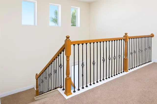 a large bed sitting in a bedroom next to a window