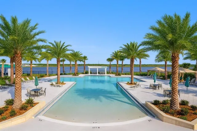 a swimming pool with outdoor seating and yard