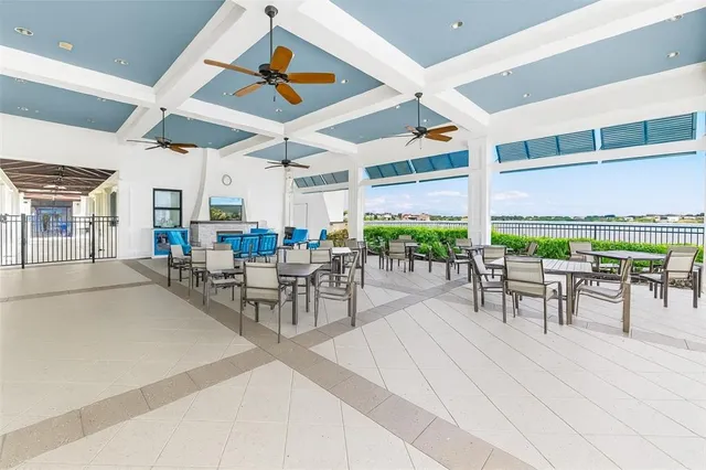 a swimming pool with outdoor seating and city view