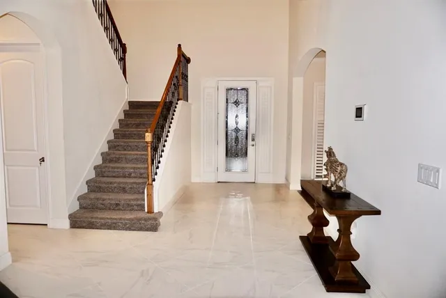 a view of entryway and hall with wooden floor