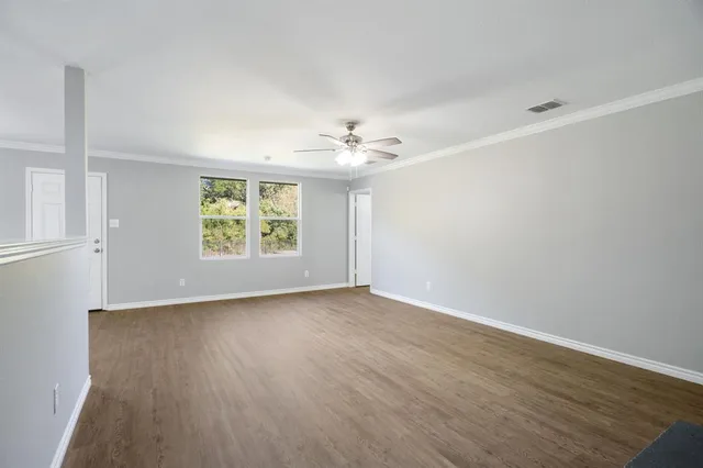 wooden floor in an empty room with a window