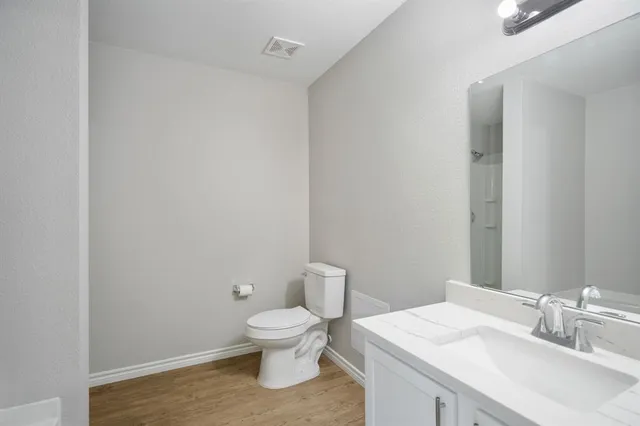 a white toilet sitting next to a bathroom sink