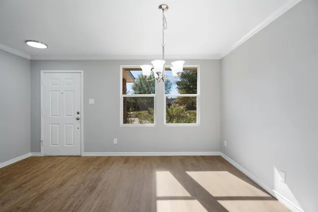 a view of a room with window and wooden floor