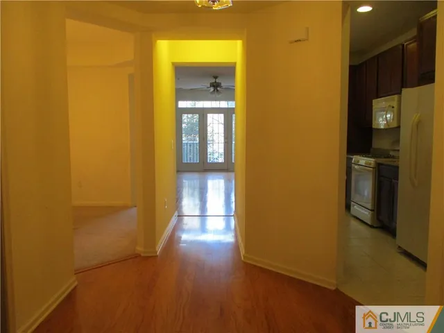 a view of a hallway with wooden floor